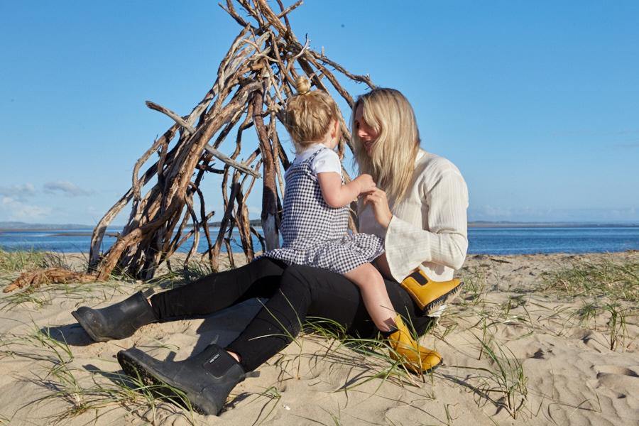 mother and child playing on a beach