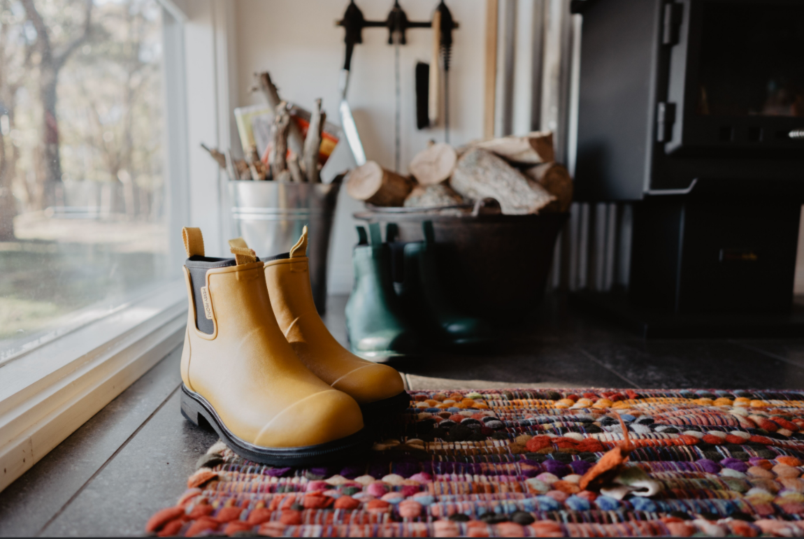 yellow merry people boots, indoors near a window